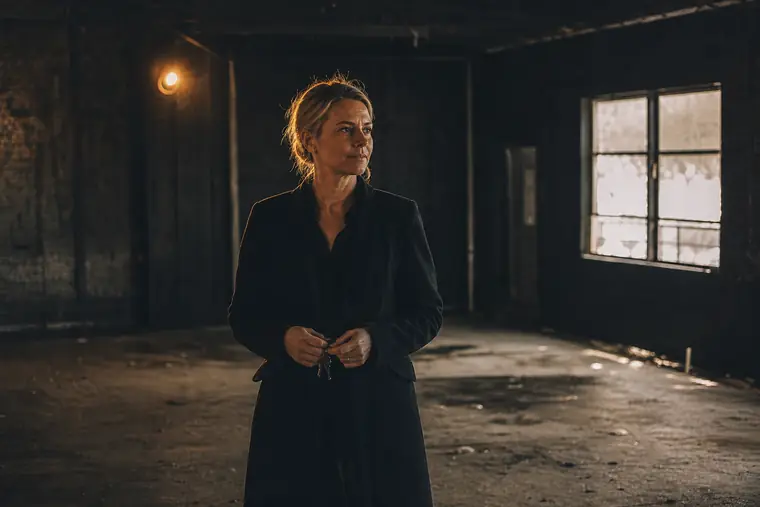 An owner standing with keys in an empty commercial space she is taking over
